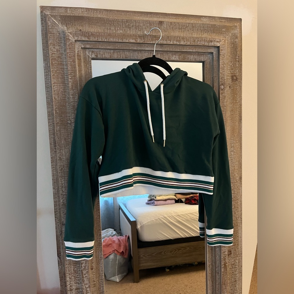Green cropped hoodie with white and gold detailing on bottom. Size S.